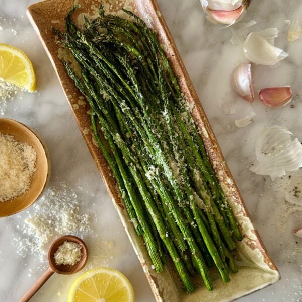 Garlic Parmesan Air Fryer Asparagus served on a plate | Healthy Foodie Girl Garlic Parmesan Air Fryer Asparagus served on a plate.