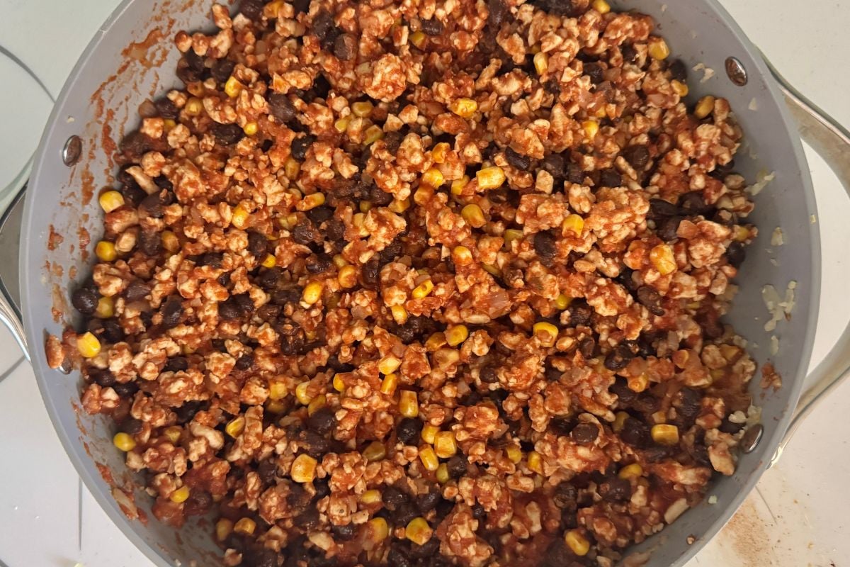 Filling for Mexican stuffed peppers in a pan.