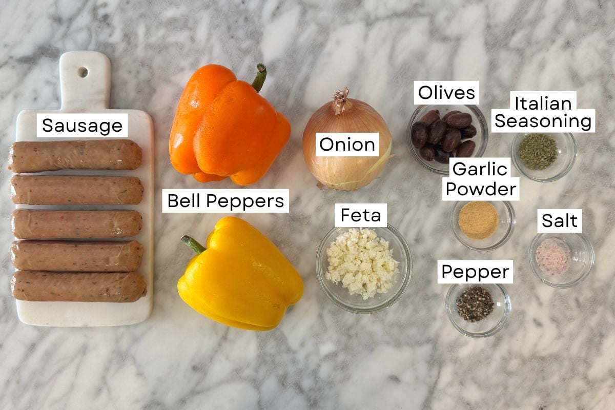 Ingredients for sheet pan sausage and peppers in bowls.