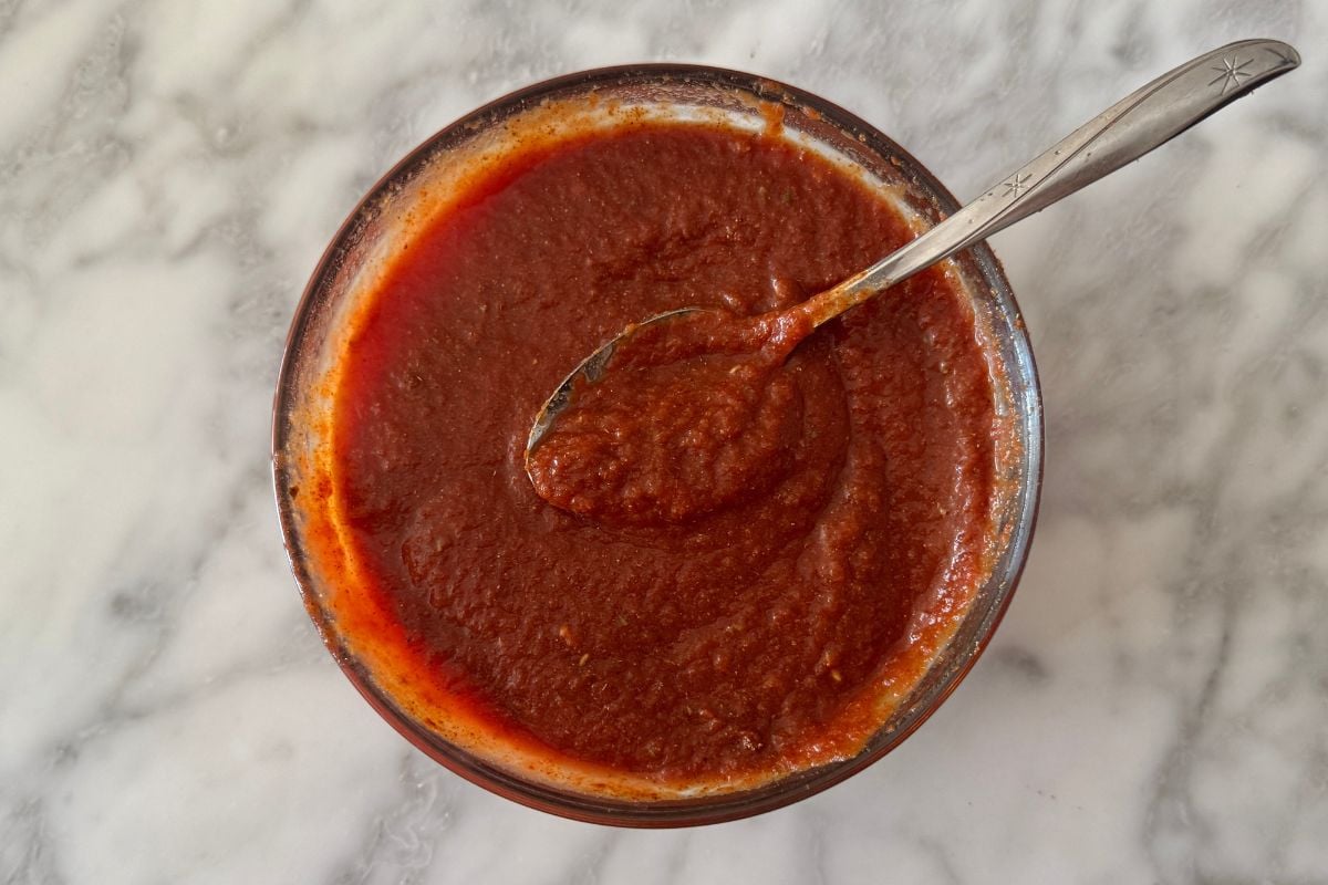Mixed tomato sauce and taco seasoning in bowl.