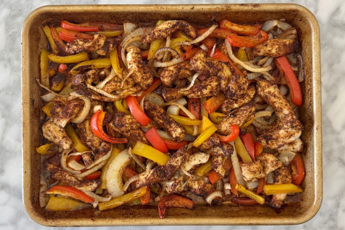 Baked chicken fajitas on sheet pan.