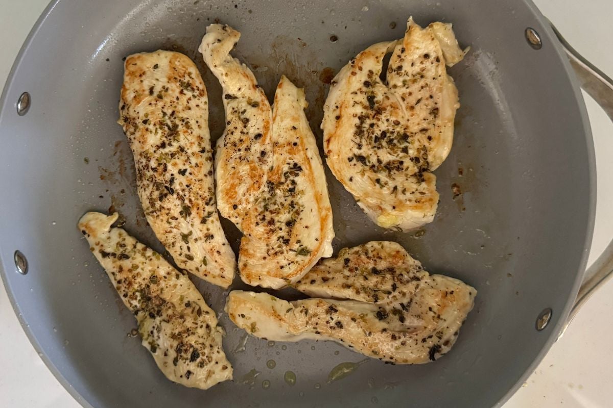 Cooked seasoned chicken in a pan.