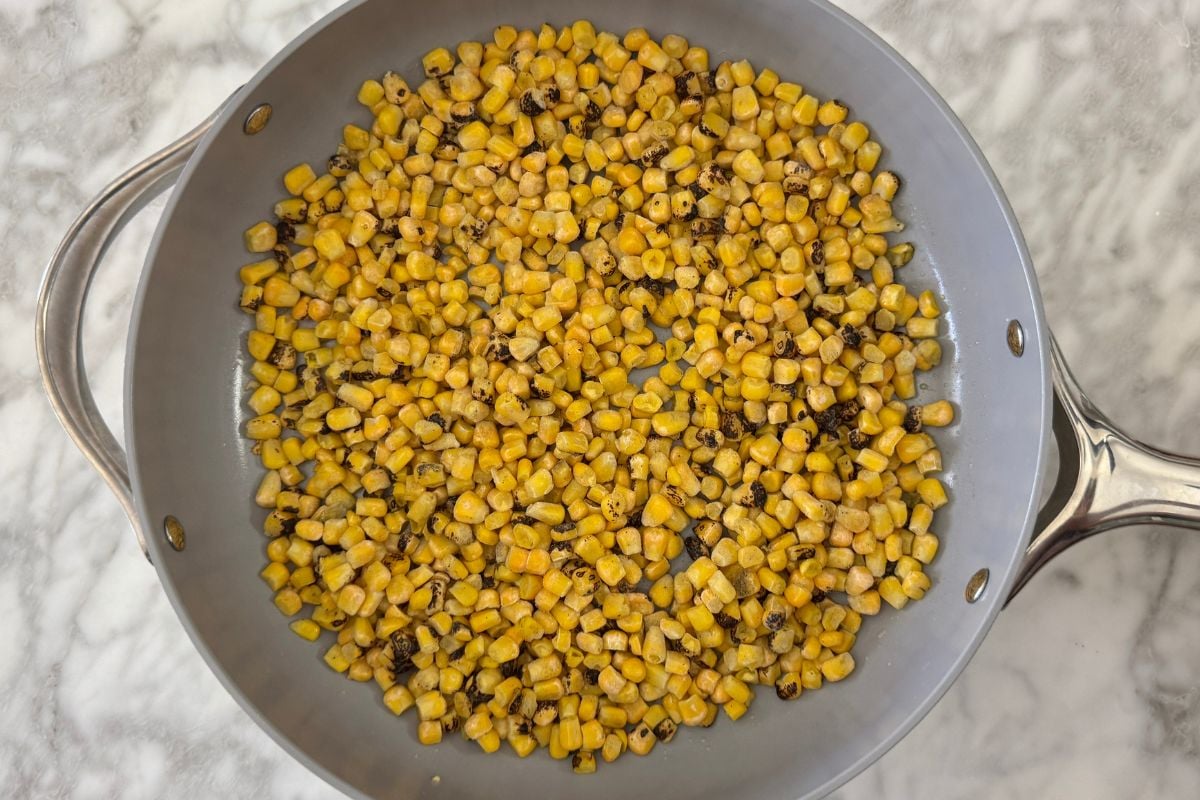 Frozen roasted corn in a skillet | Healthy Foodie Girl Frozen roasted corn in a skillet.