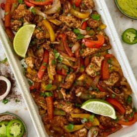 Healthy Sheet Pan Chicken Fajitas served on a sheet pan.