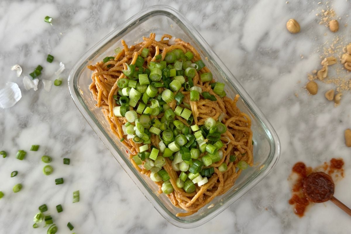 Healthy spicy peanut noodles in a storage container.