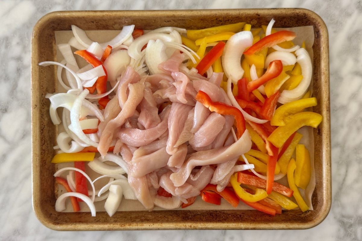 Ingredients for chicken fajitas on sheet pan.