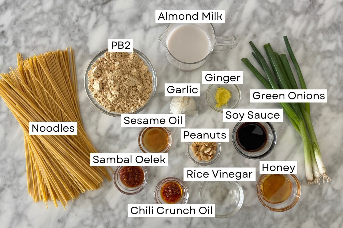 Ingredients for healthy spicy peanut noodles in bowls.