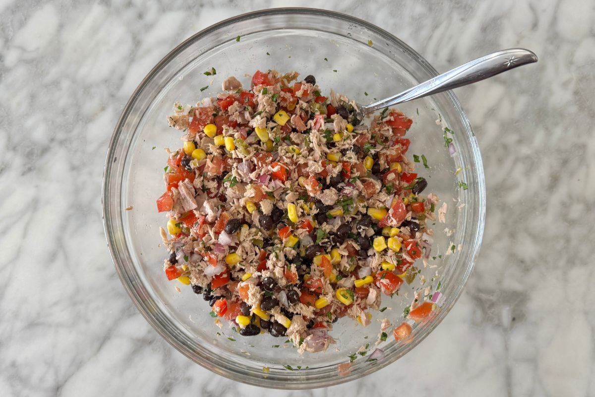 Lightly mixed Mexican tuna salad ingredients in bowl.