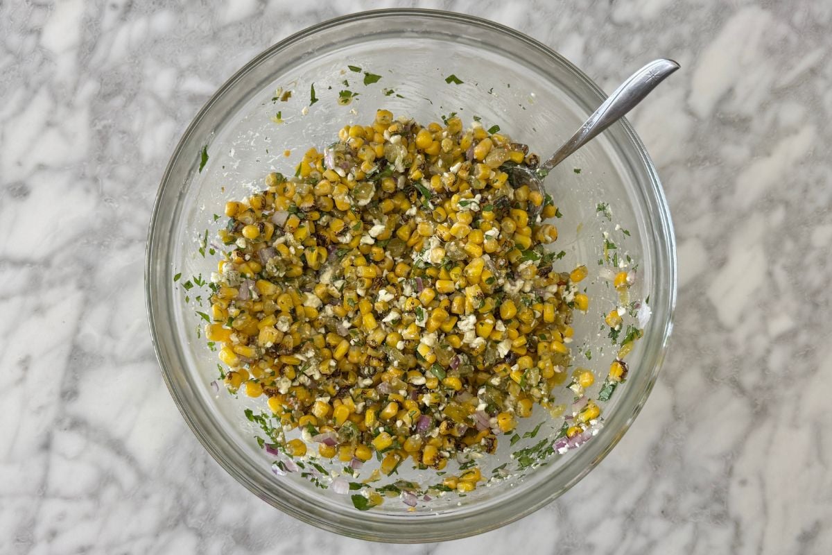 Mixed Mexican street corn salad in bowl | Healthy Foodie Girl Mixed Mexican street corn salad in bowl.