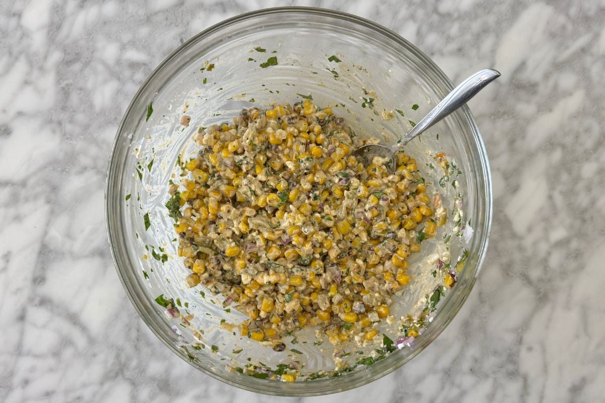 Mixed healthy Mexican street corn salad in bowl | Healthy Foodie Girl Mixed healthy Mexican street corn salad in bowl.