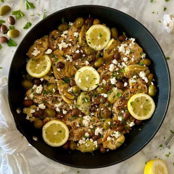 One Pan Chicken with Artichokes and Olives in a skillet.