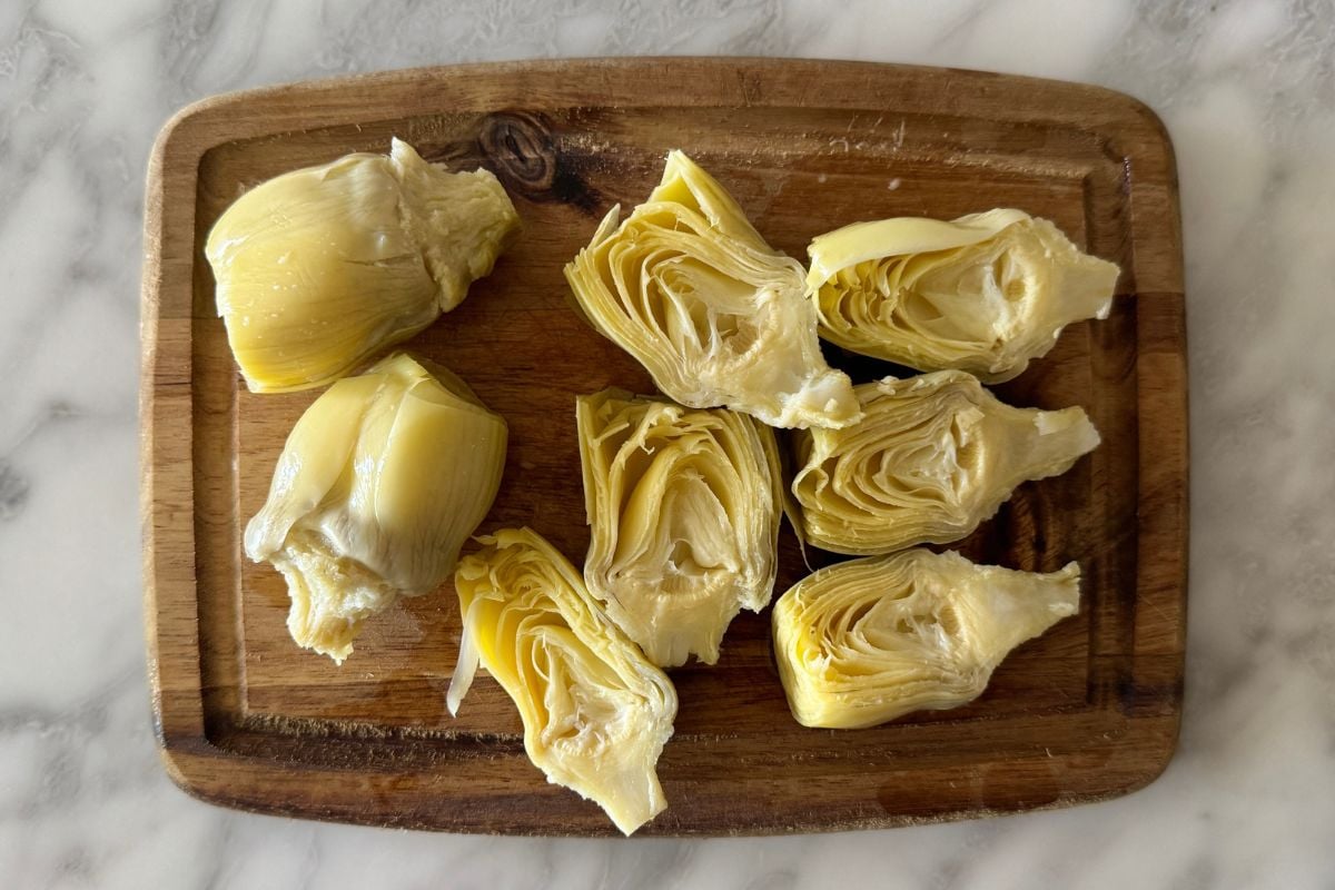Sliced artichoke hearts on a cutting board.