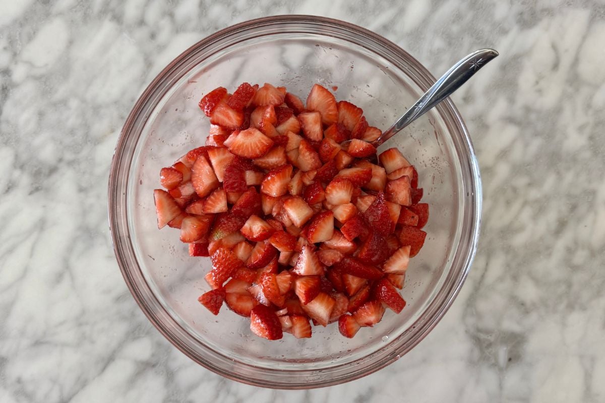 Chopped strawberries in a bowl with sweetener.