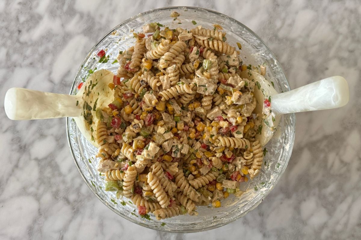 Coated street corn pasta salad in Greek yogurt dressing in bowl | Healthy Foodie Girl Coated street corn pasta salad in Greek yogurt dressing in bowl.