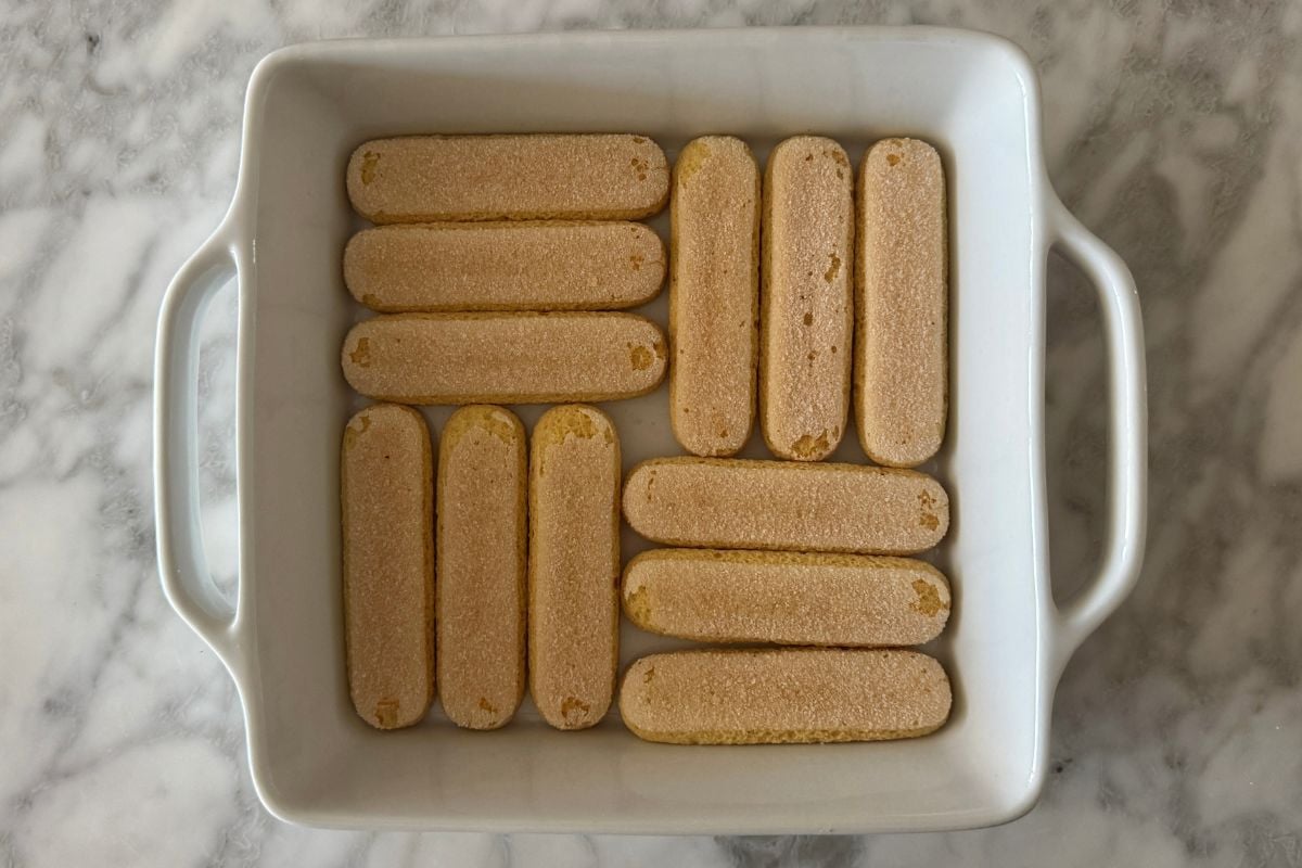 Ladyfingers arranged in a baking dish.