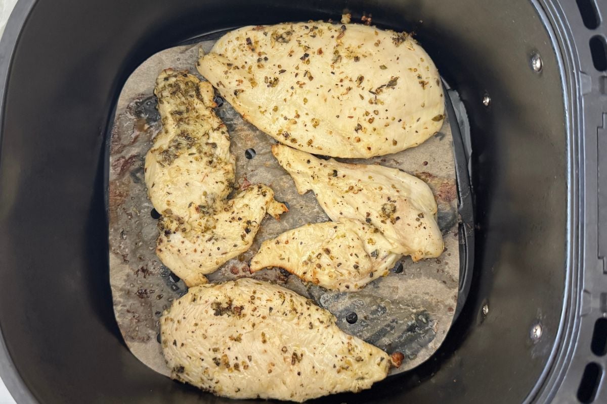 Air fried lemon garlic chicken in air fryer basket.
