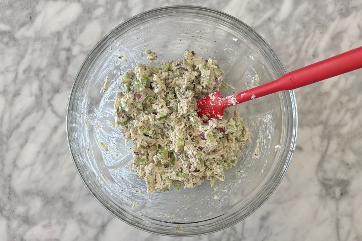 Mixed dill pickle chicken salad in a bowl.