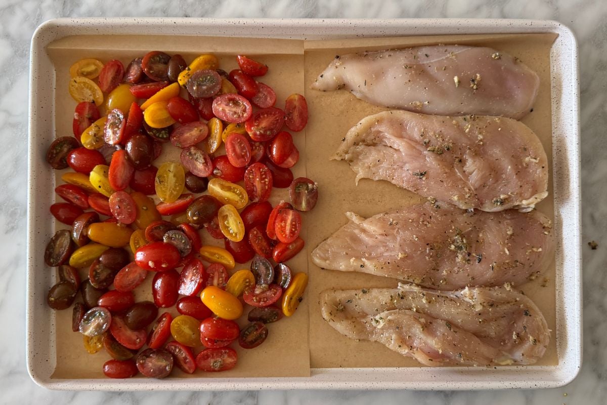 Seasoned tomatoes and chicken on a sheet pan | Healthy Foodie Girl Seasoned tomatoes and chicken on a sheet pan.