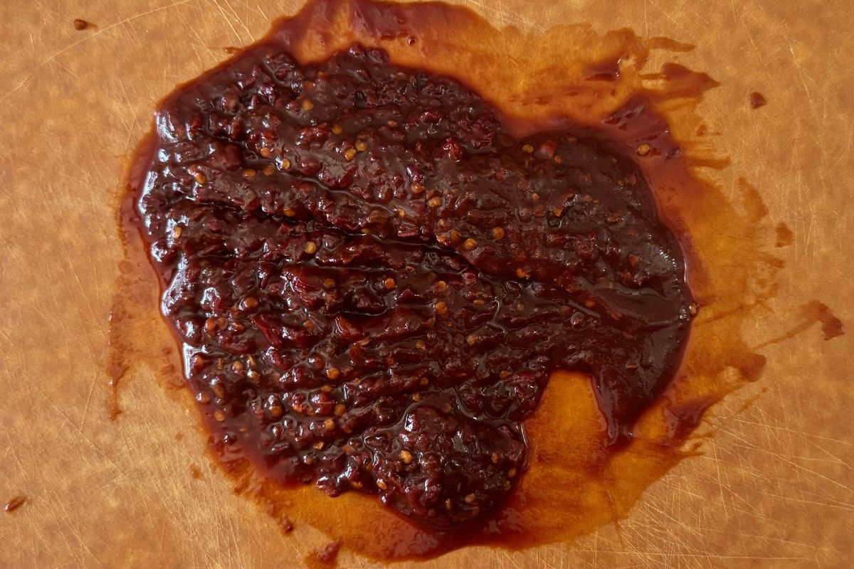 Chopped chipotle peppers in adobo sauce on cutting board.