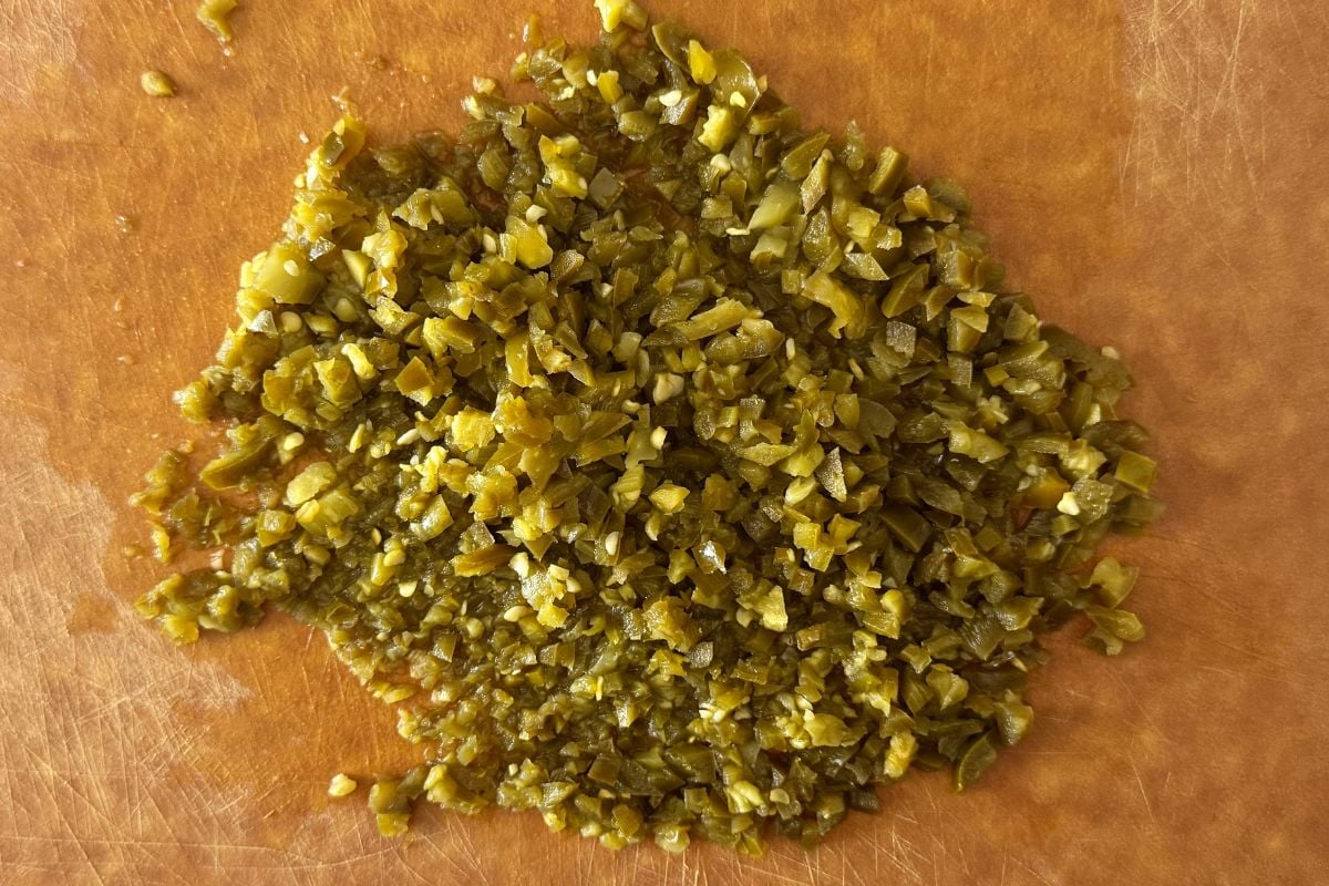 Chopped pickled jalapeños on cutting board | Healthy Foodie Girl Chopped pickled jalapeños on cutting board.