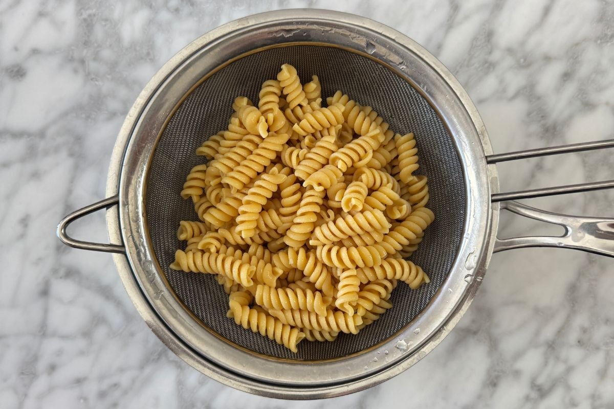 Cooked protein pasta in a strainer.