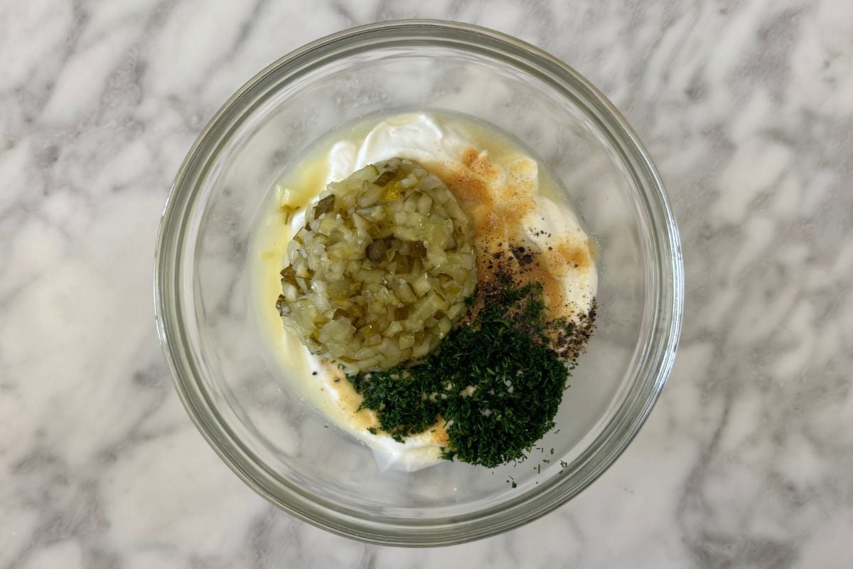 Dill pickle dip ingredients in a bowl | Healthy Foodie Girl Dill pickle dip ingredients in a bowl.