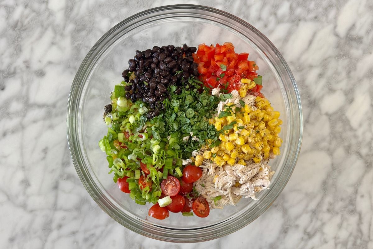 Ingredients for Southwestern chicken pasta salad in a bowl.