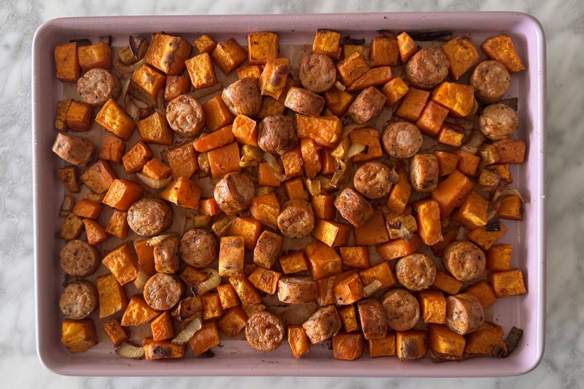 Roasted sausage and sweet potatoes on sheet pan.