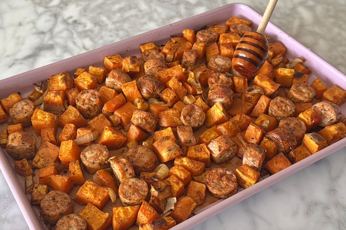 Sheet pan sausage and sheet potatoes drizzled with hot honey.