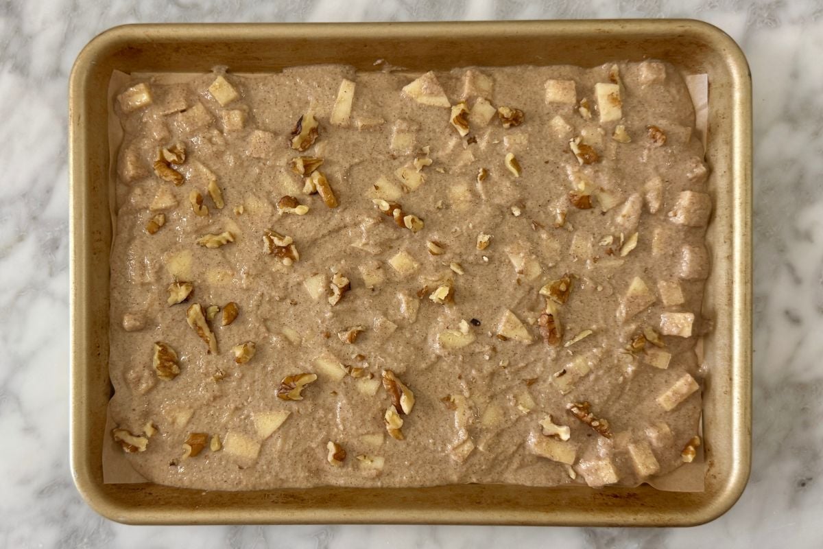 Apple cinnamon sheet pan pancakes spread on sheet pan.