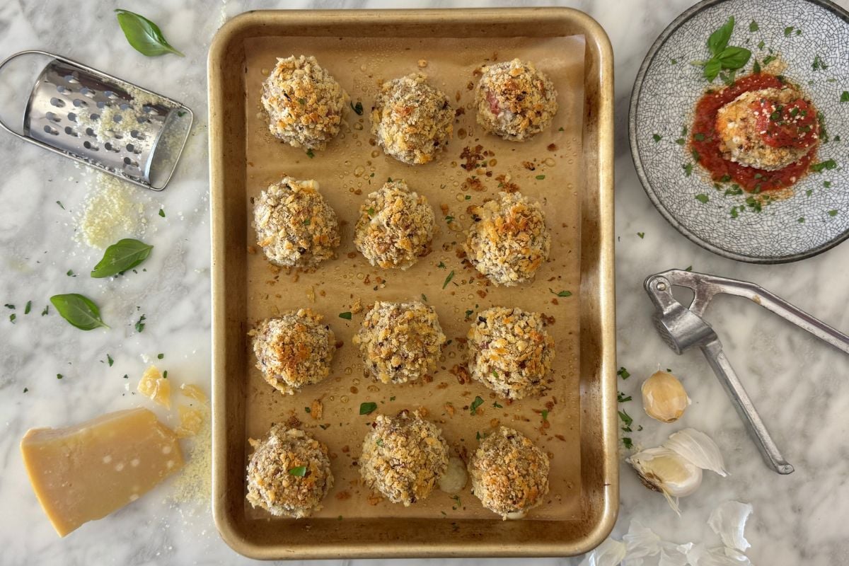 Baked turkey pizza meatballs on sheet pan.