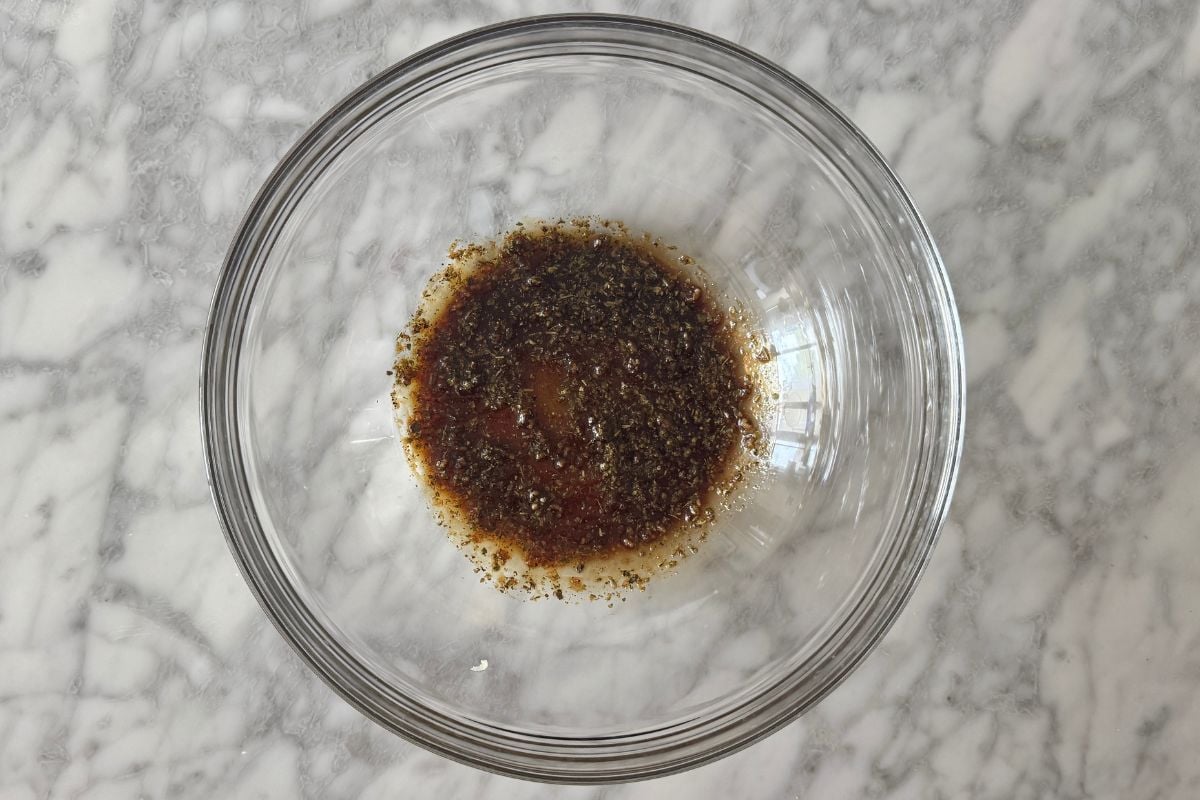 Balsamic vinegar and Italian herbs in bowl.