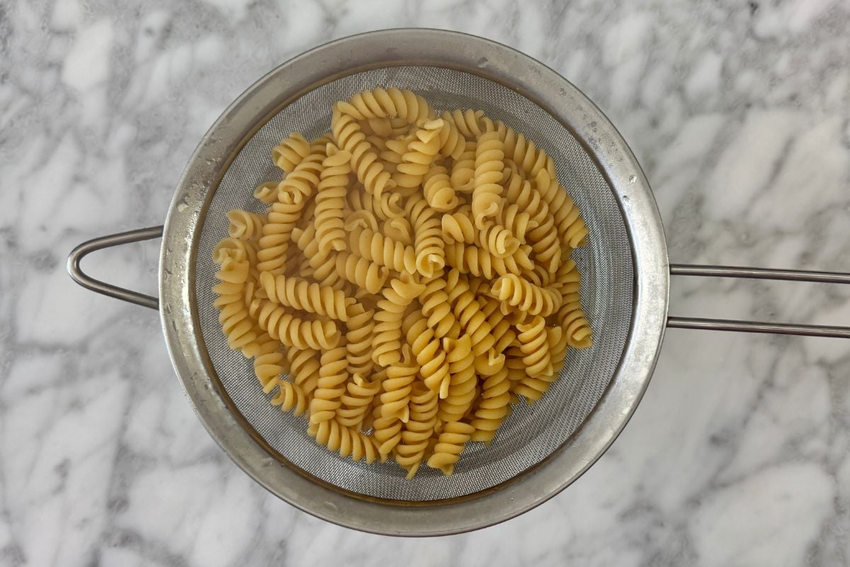 Cooked drained protein pasta in strainer | Healthy Foodie Girl Cooked drained protein pasta in strainer.