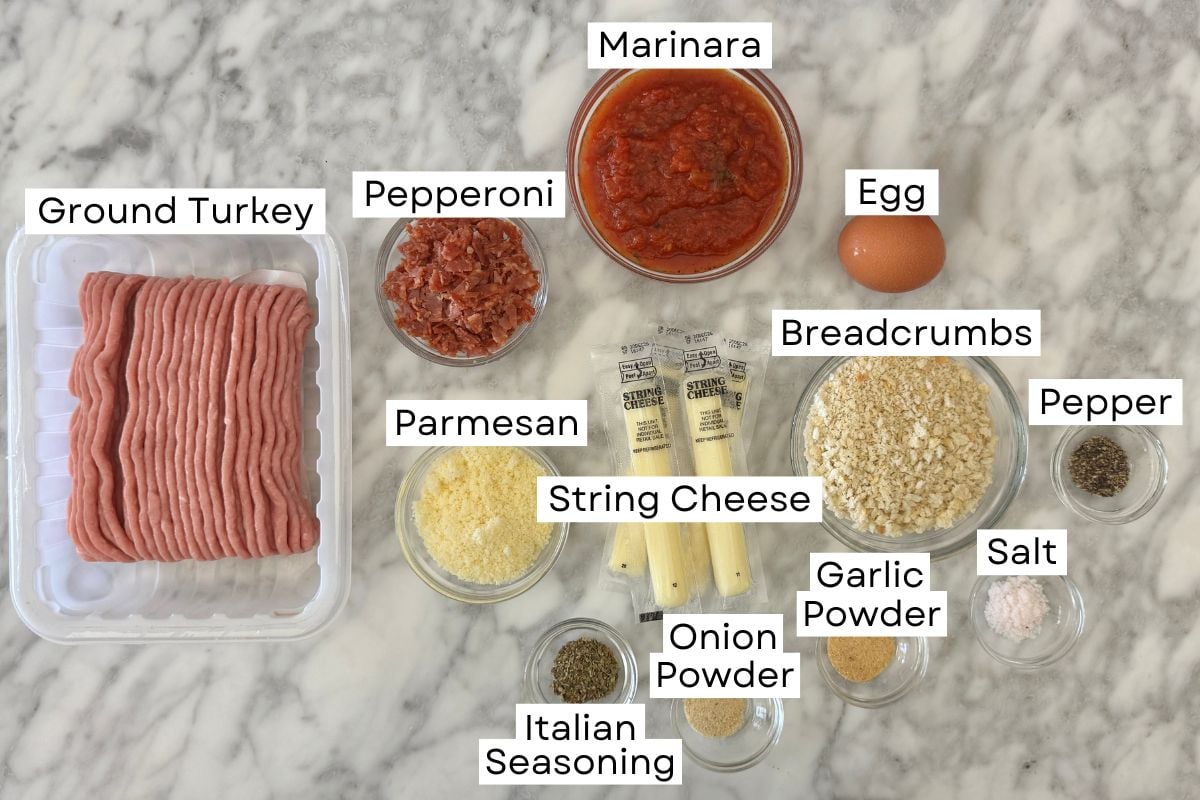 Ingredients for stuffed turkey pizza meatballs with pepperoni in bowls.