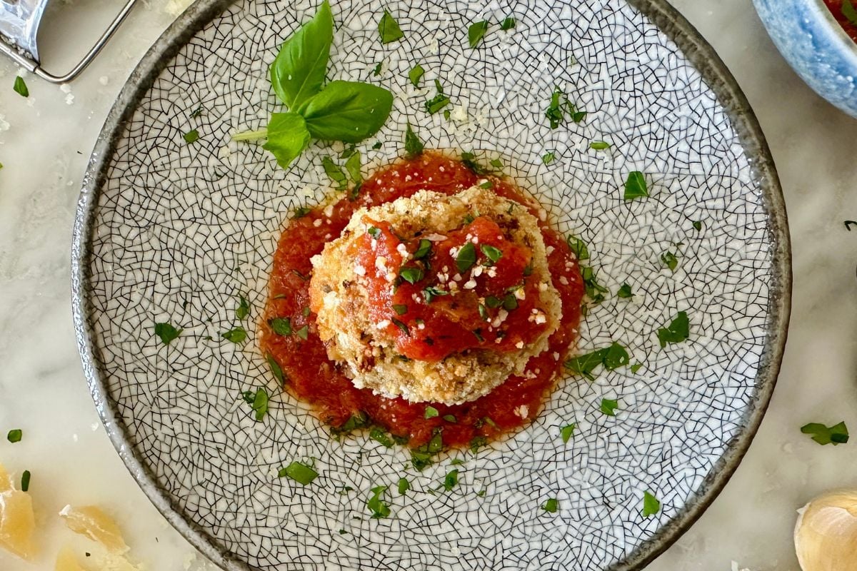 Pizza meatball on a plate with marinara.