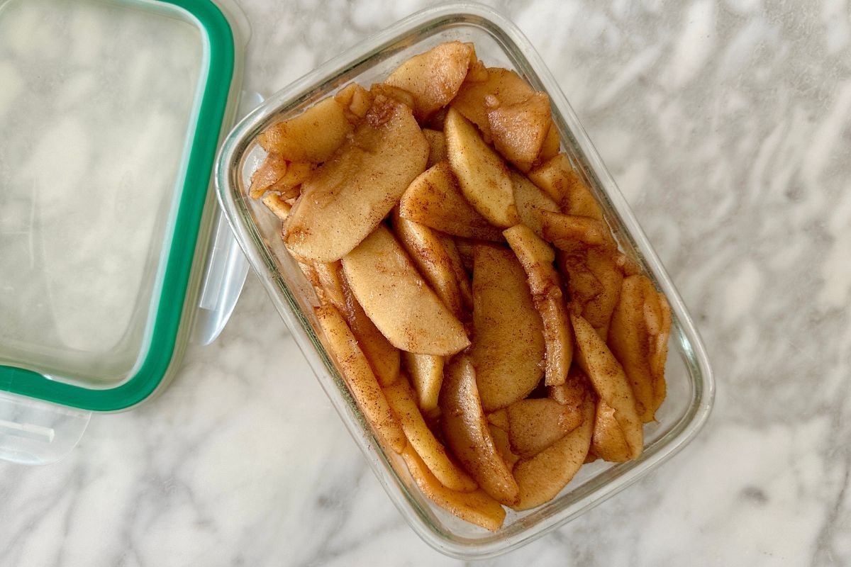 Slow cooker cinnamon apples in a storage container.