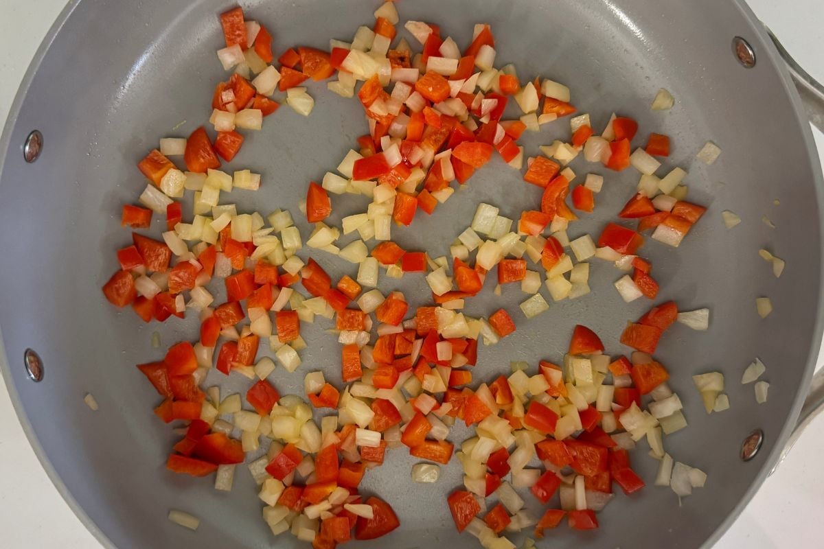 Bell pepper and onion in a pan.