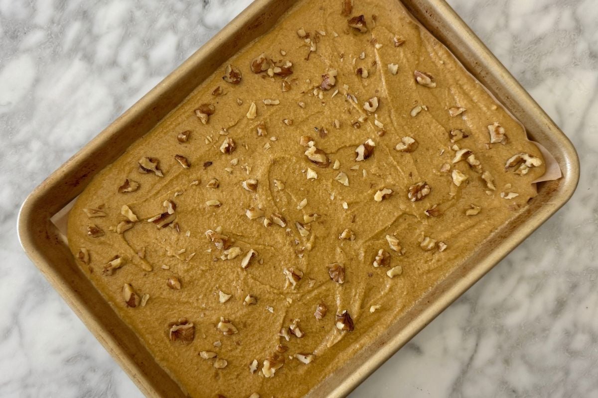 Walnuts sprinkled over pancake batter | Healthy Foodie Girl Walnuts sprinkled over pancake batter.